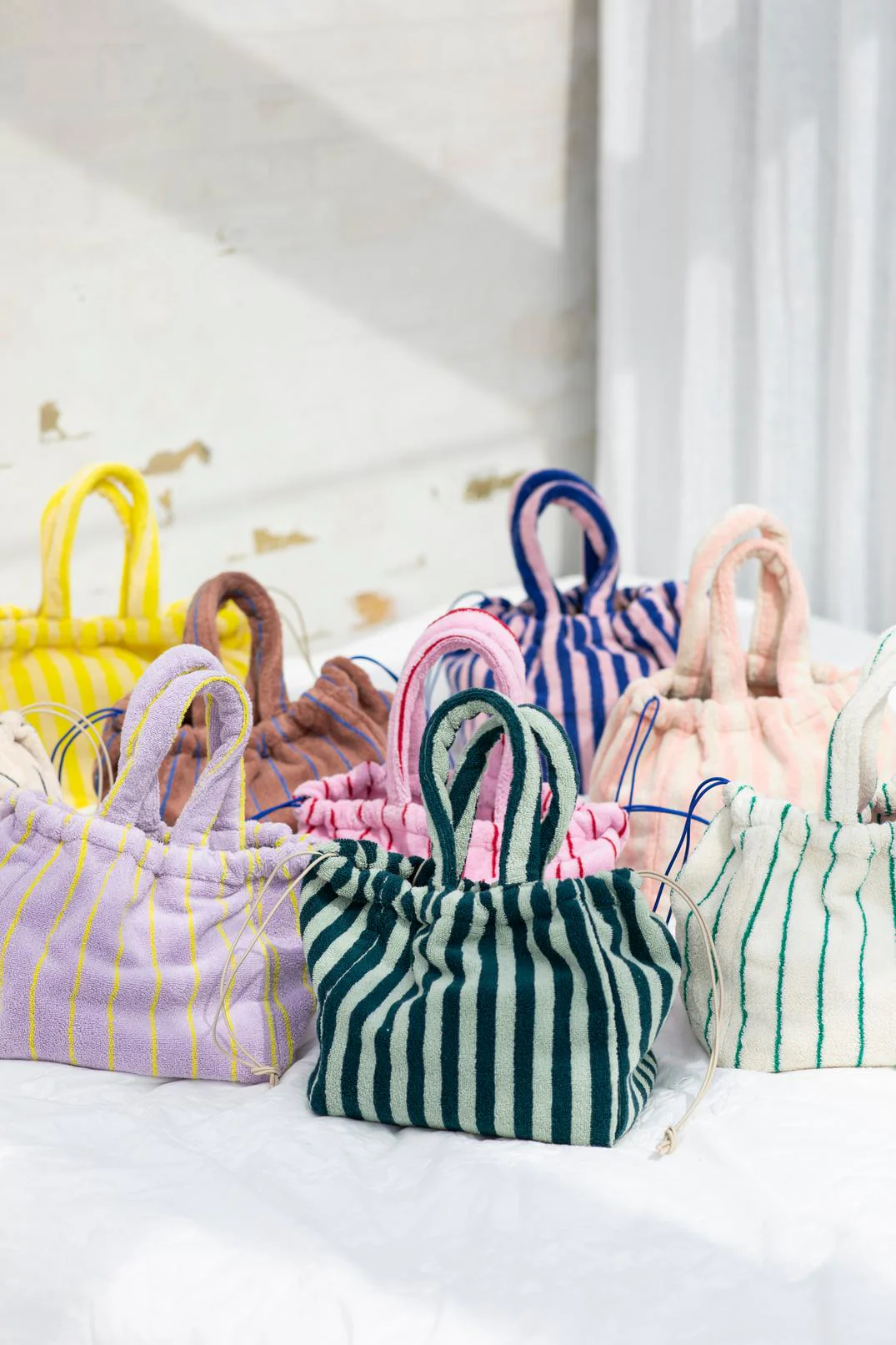 a collection of striped Terry towel bucket bags from Bongusta Naram Handbag Small